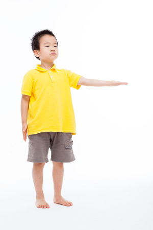 Asian boy showing something isolated on white.の写真素材
