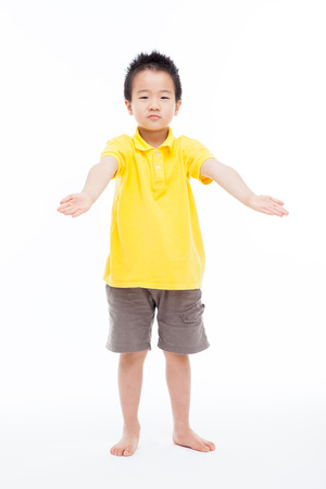 Asian boy showing something isolated on white.の写真素材