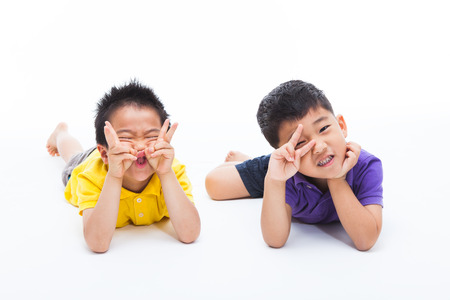 Joyful Asian two boys isolated on white.の写真素材