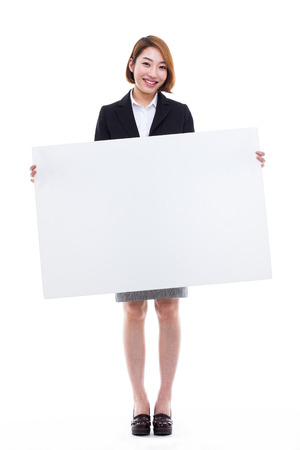 Young Asian business woman holding a blank banner isolated on white background.の写真素材