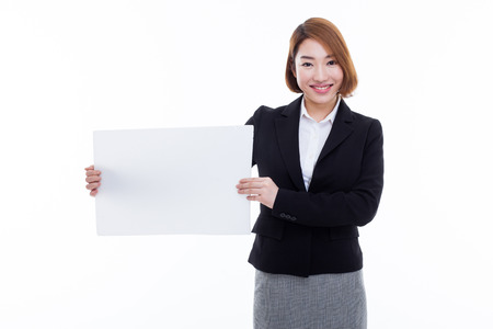 Young Asian business woman holding a blank banner isolated on white background.の写真素材