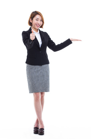 Asian business woman indicate blank space isolated on white background.の写真素材