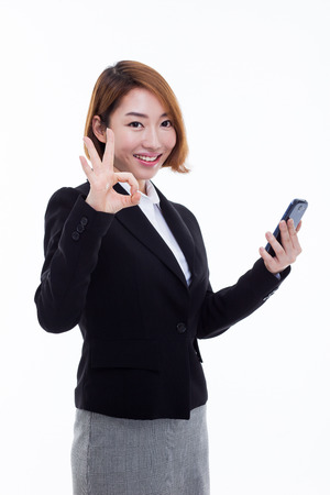 Business man with smart cell phone isolated on white background.の写真素材