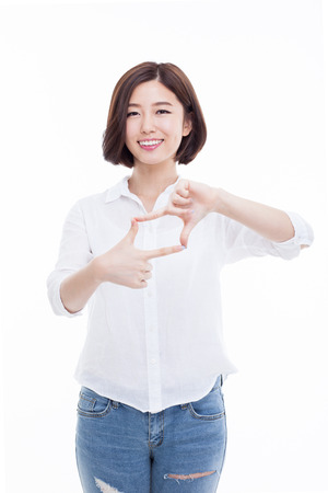 Young Asian woman taking photo isolated on white background.の写真素材