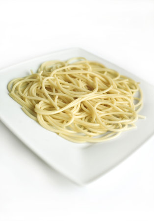 The composition of the macaroni on the plate standing on the white background.の写真素材