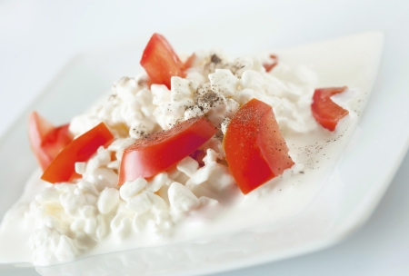 The dish from the coottage cheese, the sour cream, tomates, strewn with the Black pepper and saltの写真素材