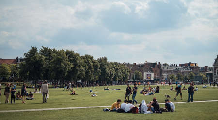 Amsterdam, Netherlands - 4 August, 2019: People walking and relaxing around The Museumplein (Museum square), a public space in the Museumkwartier neighborhood on sunny dayのeditorial素材