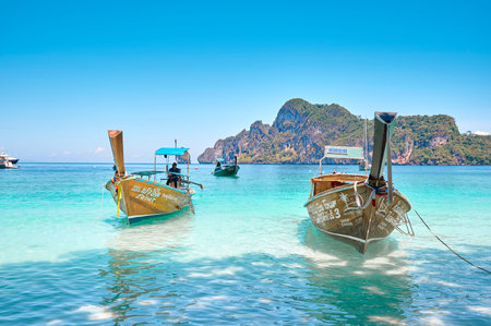 The Landscape of beach and ocean on a sunny day at Phi Phi Islands with a tourist boat, Thailand