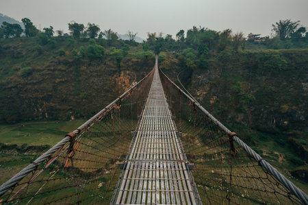 The famous Bhalam suspension bridge near Pokhara offers a breathtaking view of the Seti riverbank, attracting tourists to admire the scenic landscape.の写真素材