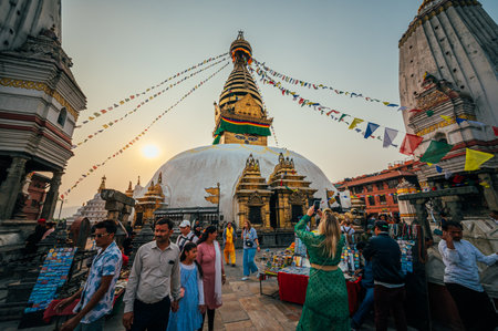 Bhaktapur, Nepal - Apr 16, 2023: Tourists ans local visiting the Swayambhunath temple, an ancient religious complex atop a hill in the Kathmandu Valley, Nepalのeditorial素材