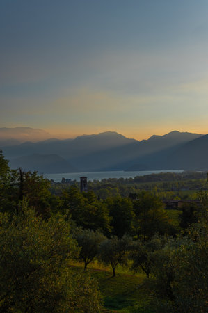 A landscape of the countryside near Iseo Lake at sunrise near the cities of Brescia. Iseo Lake also known as Sebino, is the fourth largest lake in Lombardy, Italyの写真素材