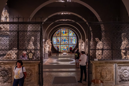 Siena, Italy - Aug 9,2023: A view inside the Siena Cathedral Museum, featuring a stunning stained glass window and surrounding statues.のeditorial素材