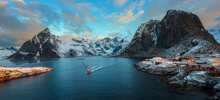 Scenic view of Hamnoy in Lofoten Island with snow-capped mountains in the background at sunset.の写真素材