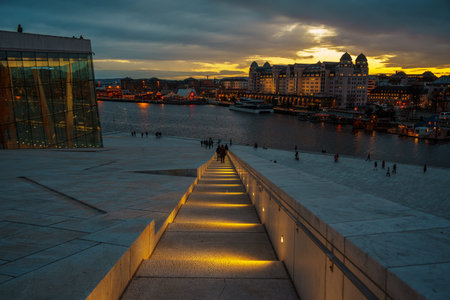 Oslo, Norway - Apr 13, 2024: A landscape of Oslo Opera House with people walking and relax around...