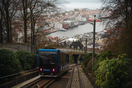 Iconic Floibanen funicular railway ascending Mount Floyen in Bergen, Norway, offering panoramic...