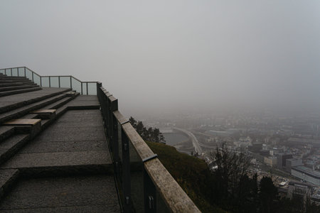Misty aerial views from Mount Floyen in Bergen, Norway, showing the harbor, city center, and...