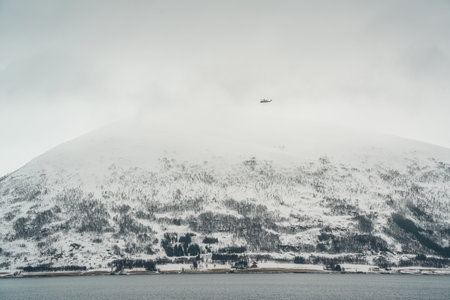 Icy fjords, snow-covered towns, foggy mountains, and serene sea views captured aboard the Hurtigruten cruise from Lofoten to TromsÃ¸, Norway.の写真素材