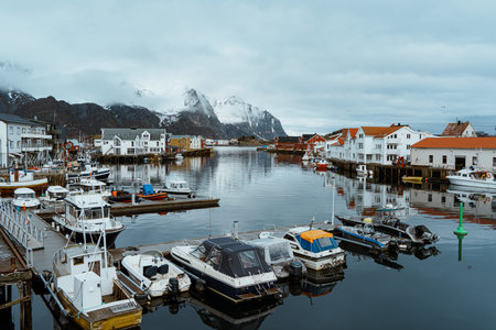 Picturesque harbor view of Henningsvaer, Lofoten, Norway, with fishing boats, traditional buildings,...