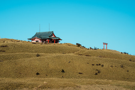 A red torii gate leads to the mountaintop Hakone Mototsumiya Shrine under a clear sky. Hakone, Japan.の写真素材