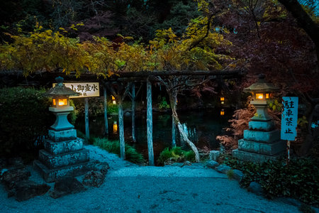 Fujinomiya, Japan - Dec 11, 2023: A peaceful pool surrounded by traditional stone lanterns and lush greenery at Fujisan Hongu Sengen Taisha Shrine in Fujinomiya.の写真素材