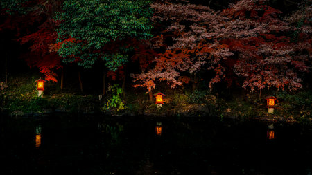 Fujinomiya, Japan - Dec 11, 2023: A peaceful pool surrounded by traditional stone lanterns and lush greenery at Fujisan Hongu Sengen Taisha Shrine in Fujinomiya.の写真素材