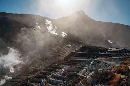 Dramatic geothermal landscape of Owakudani in Hakone, Japan, featuring rising steam vents, rugged terrain, and a scenic ropeway ride.の写真素材