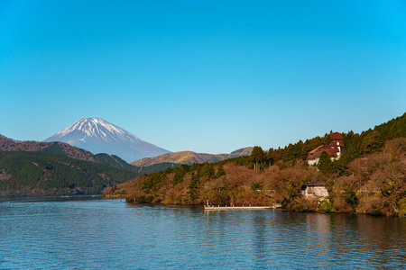 Peaceful morning scene in Hakone, Japan, featuring Lake Ashi, forested hills, and majestic Mount...