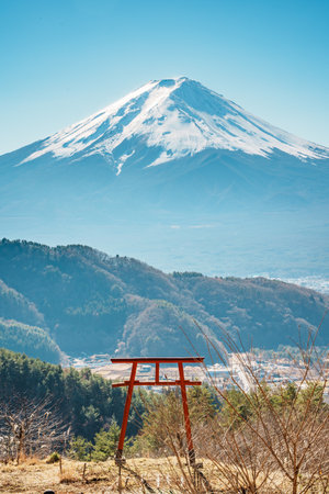 Torii gate on hill with panoramic view of Mount Fuji and Kawaguchiko Lake.の写真素材