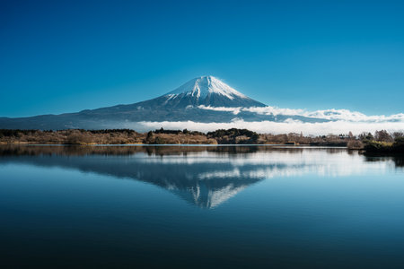 Mount Fujiâs reflection at Lake Tanuki, clear sky, and serene nature.の写真素材