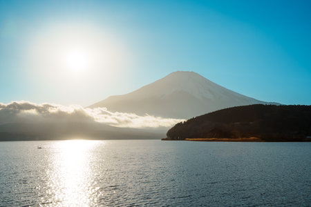 Stunning sunrise over Lake Yamanaka, with the magnificent silhouette of Mount Fuji.の写真素材