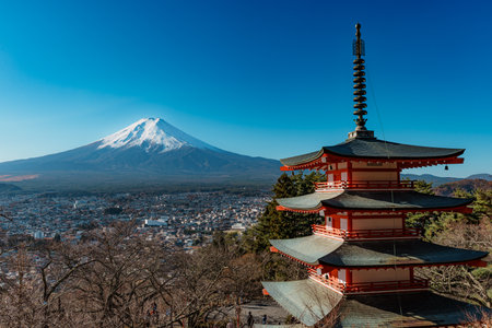 Iconic Chureito Pagoda with Mount Fuji and Fujiyoshida city in a panoramic view under blue sky.の写真素材