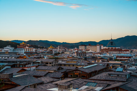 View of Shangri-La city and a mountain valley set against a dramatic sunset sky.の写真素材