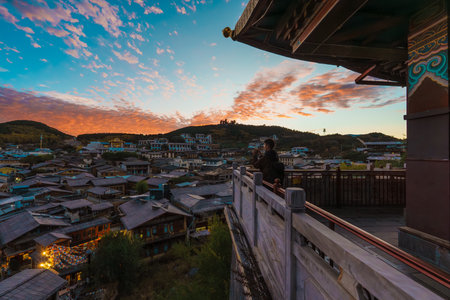 A stunning view of Dukezong Ancient Town at twilight from a temple or guesthouse balcony in Shangri-La, Yunnan.の写真素材