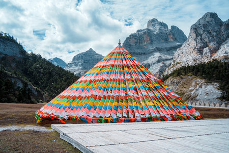 Balagezong, China - Oct 22, 2024: Colorful prayer flags and sacred mountain scenery near Shambhala Pagoda in Balagezong, Chinaの写真素材