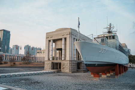 Decommissioned naval Patrol Boat 357 stands on blocks beside a neoclassical pavilion at the War...