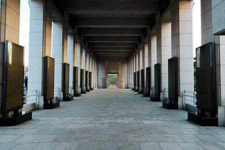 Long colonnade lined with memorial name panels at the War Memorial of Korea, Seoul, captured with...