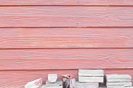 horizontal wooden texture red color and broken gray brick