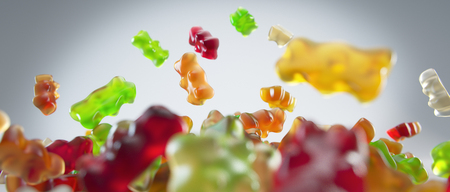 Transparent colorful sweet gummy bears falling backgroundの写真素材