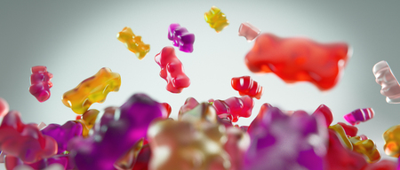 Transparent pink and red sweet gummy bears falling backgroundの写真素材