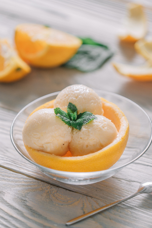 ice cream balls of different colors are on white plates in still lifeの写真素材