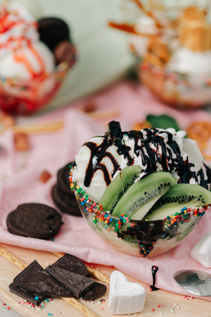 ice cream balls of different colors are on white plates in still lifeの写真素材