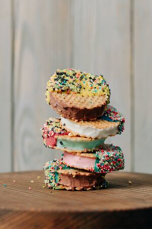 ice cream on a stick lies on a wooden background in different positions