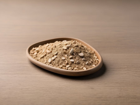 Powdered oats in a wooden bowl on a wooden tableの素材