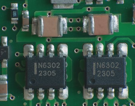 Close up electronics parts on green board