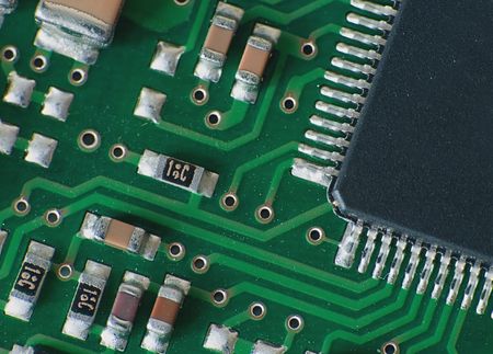 Close up electronics parts on green board