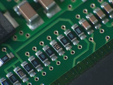Close up electronics parts on green board