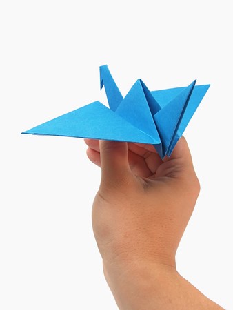 Origami crane in handの写真素材
