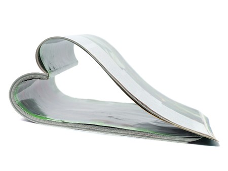 Curved magazine isolated on white background の写真素材