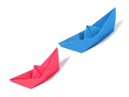 Close up origami ship over white の写真素材