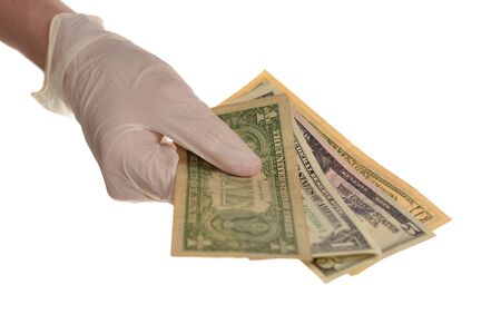 Hand in protective gloves with money isolated on white background.の写真素材